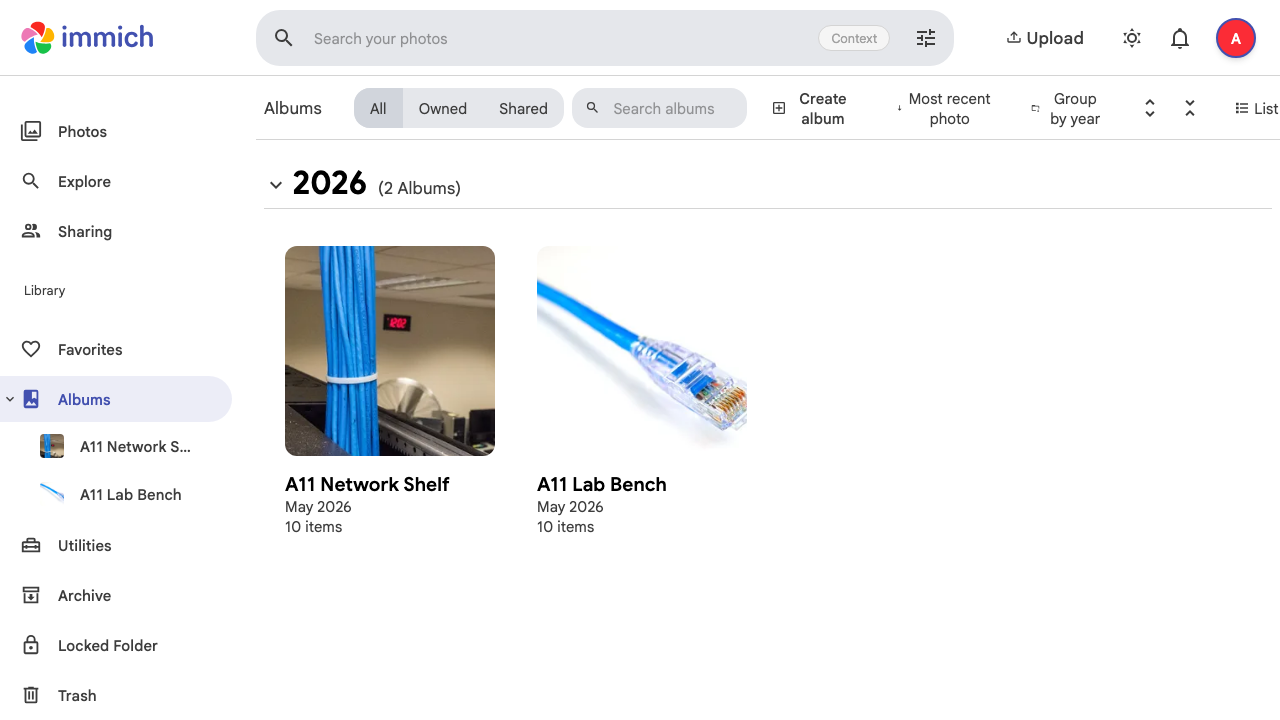 Restored Immich albums page showing A11 Network Shelf and A11 Lab Bench albums with ten items each.